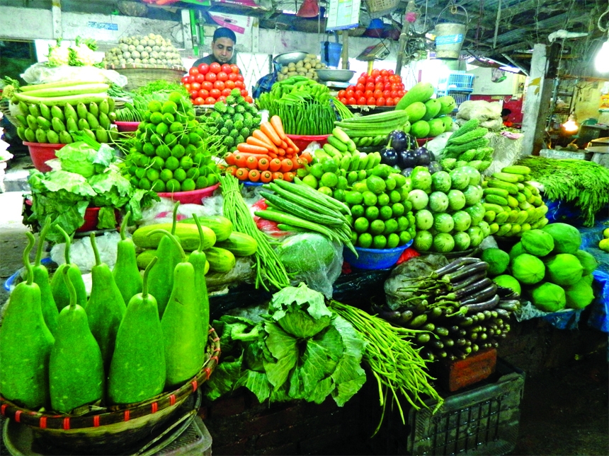 A vendor wait for customer at his vegetable shop in the capital's Shantinagor kitchen market on Friday.