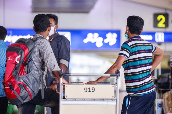 Migrant workers at the departure gate of Velana International Airport (VIA). (File Photo)