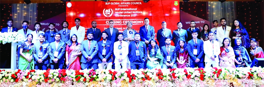 Education Minister Dr. Dipu Moni poses for a photo session with winners of 'BUP International Model United Nations Conference-2021' in its Bijoy Auditorium in the city on Saturday.