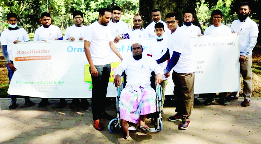 Accessibility Champion of google Kamal Hasnain distributes wheel chair among the disabled at a human chain formed by Ornaments of Accessibility at Ramna Park in the city on Saturday.