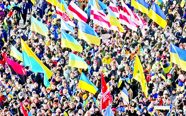 People take part in the Unity March, which is a procession to demonstrate Ukrainians' patriotic spirit amid growing tensions with Russia, in Kyiv, Ukraine on Saturday.