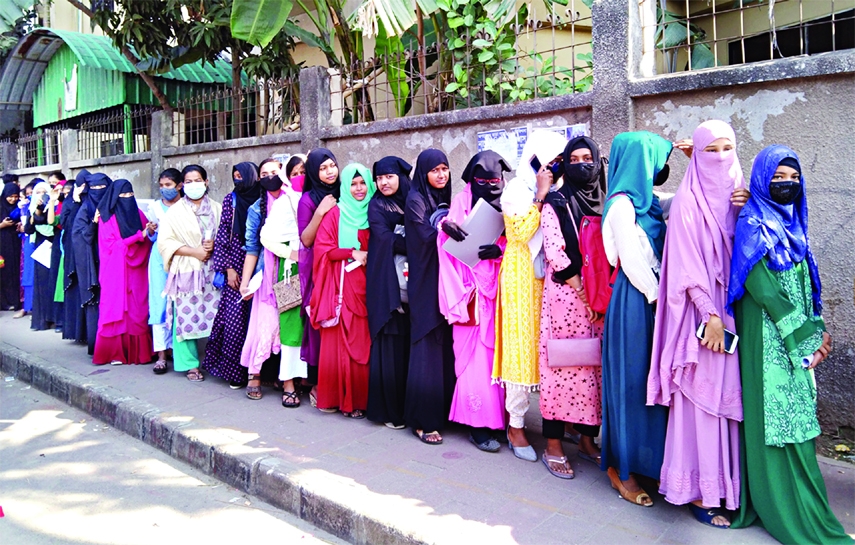 Girl students jostle in a queue to get vaccinated against Covid-19 at a center in the capital's Eskaton area on Saturday. Earlier, Bangladesh started administering COVID-19 vaccines to school children aged 12-17 years in Dhaka.