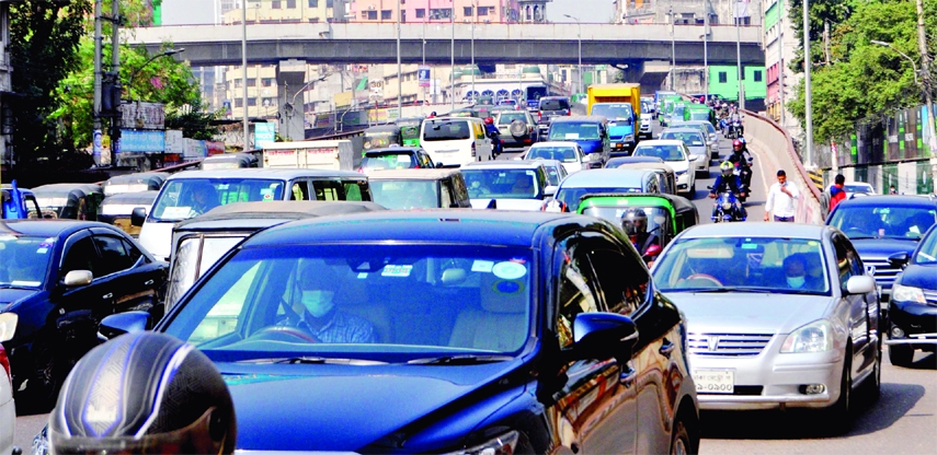Hundreds of vehicles get stuck in tailback at Moghbazar area in the capital on Sunday.
