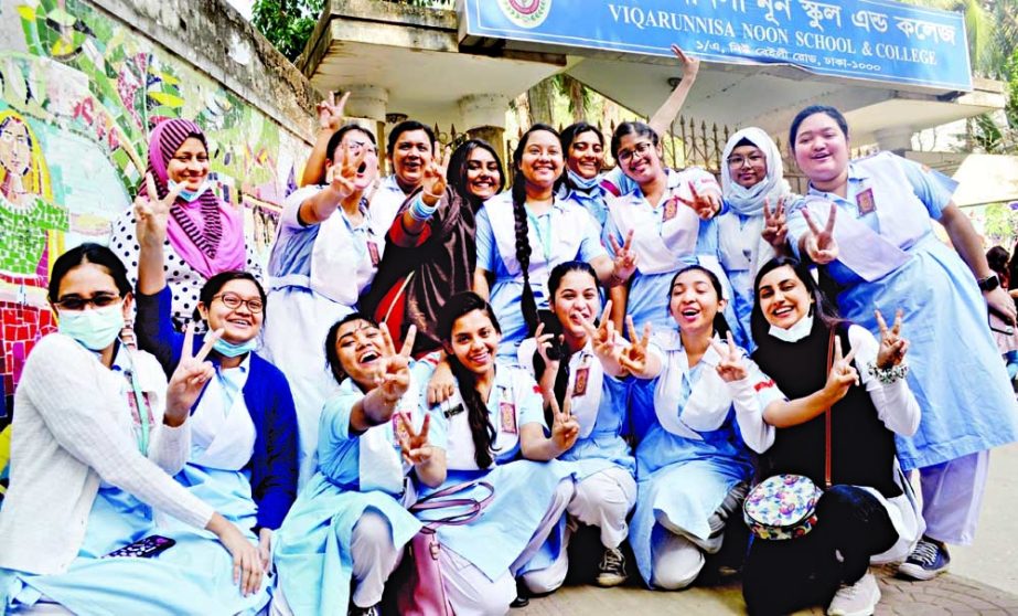 Students flash the ‘V’ sign at Viqarunnisa Noon School and College as they celebrate their HSC results on Sunday. NN photo