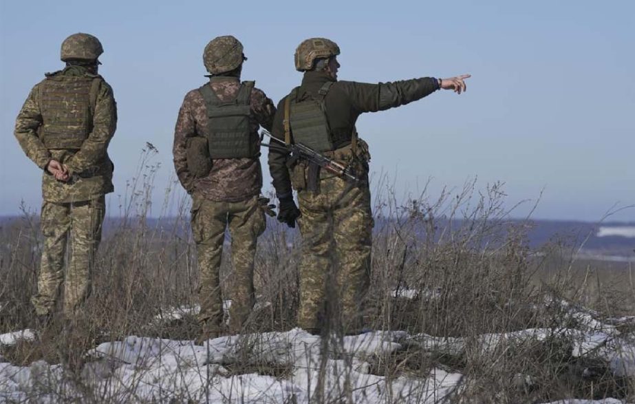 Ukrainian servicemen survey the impact areas from shells that landed close to their positions during the night on a front line outside Popasna, Luhansk region, eastern Ukraine, Monday, Feb. 14, 2022.