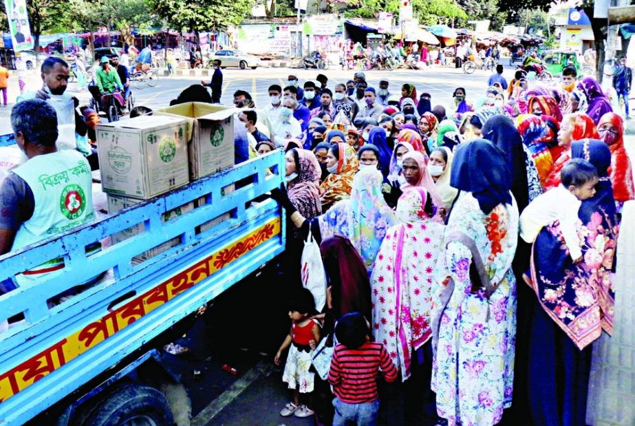 People jostle for buying goods at an OMS centre of Trading Corporation of Bangladesh (TCB ) in the capital on Wednesday amid soaring prices of daily essentials. NN photo