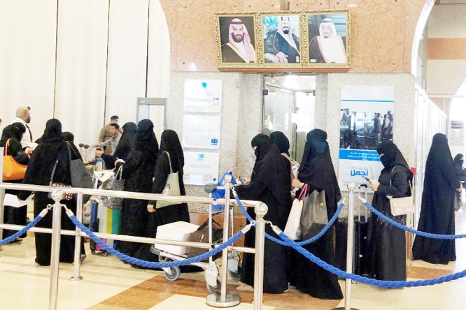 Saudi women are seen in line at the Dammam railway station.