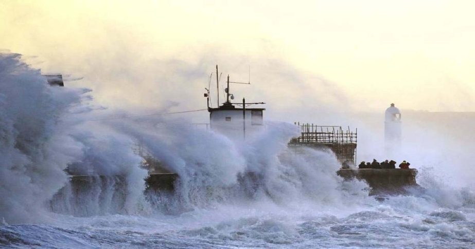 Waves crash against the sea wall and Porthcawl Lighthouse in Porthcawl, Bridgend, Wales, Britain, as Storm Eunice makes landfall Friday, Feb. 18, 2022.