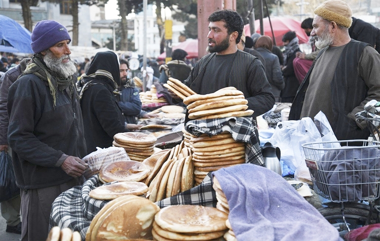A man buys bread at a market in Kabul on Wednesday.