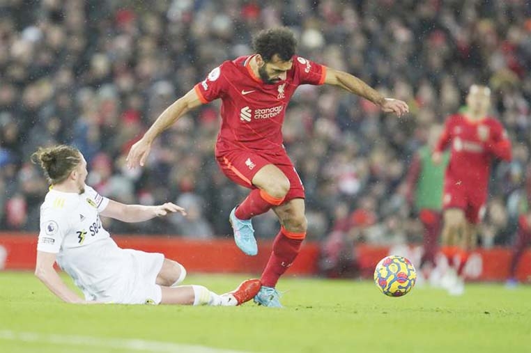 Liverpool's Mohamed Salah (right) fights for the ball with Leeds United's Luke Ayling during the English Premier League soccer match between Liverpool and Leeds United at Anfield stadium in Liverpool, England on Wednesday.