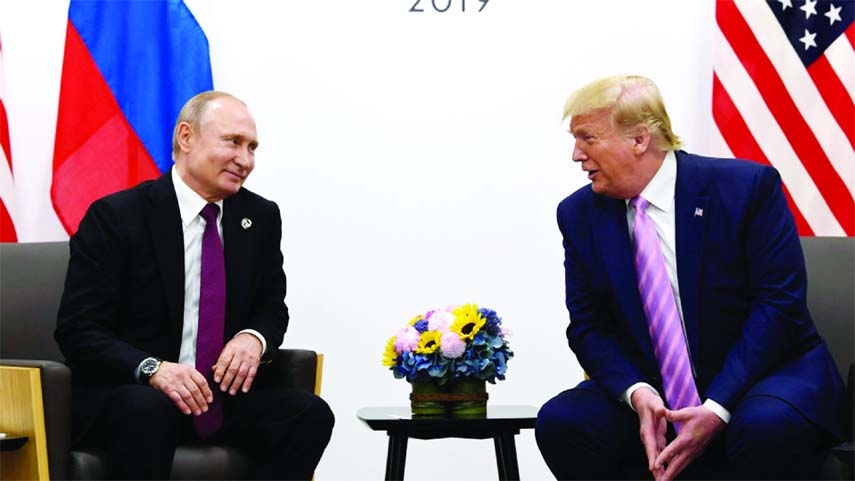 June 28, 2019, file photo, President Donald Trump, right, meets with Russian President Vladimir Putin during a bilateral meeting on the sidelines of the G20 summit in Osaka, Japan.