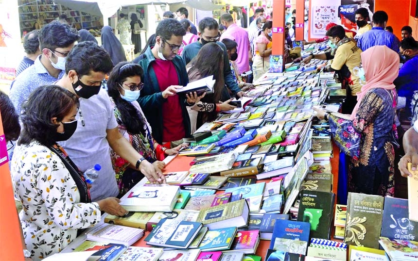 Book lovers crowd at a stall of Bangla Academy Amar Ekushey Book Fair on Friday, the weekly holiday.