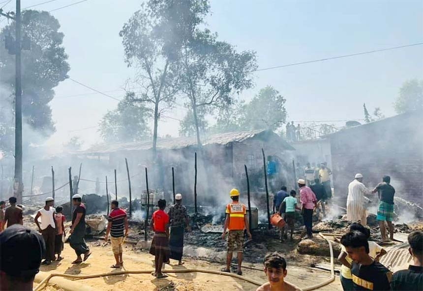 Fire service personnel try to douse fire that broke out at Ukhiya Rohingya Camp in Cox's Bazar on Friday that gutted 30 shacks, 15 shops.