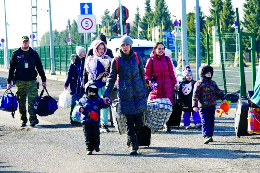 Ukrainian women and children cross the border from Ukraine to Poland at the Korczowa-Krakovets border crossing on Saturday.