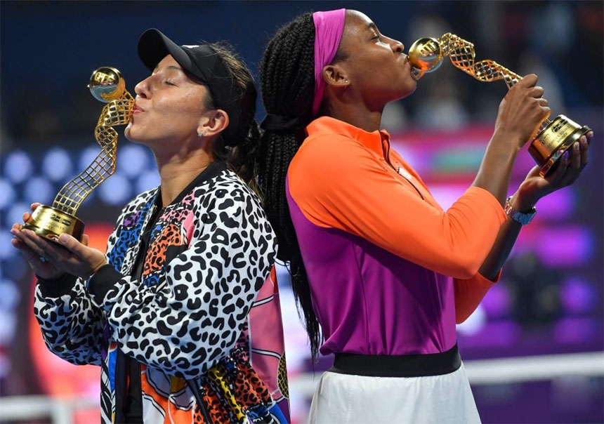 Cori Gauff (right) and Jessica Pegula of the United States pose with their trophies after the doubles final of the WTA Qatar Open tennis tournament against Veronica Kudermetova of Russia and Elise Mertens of Belgium in Doha, capital of Qatar on Friday.