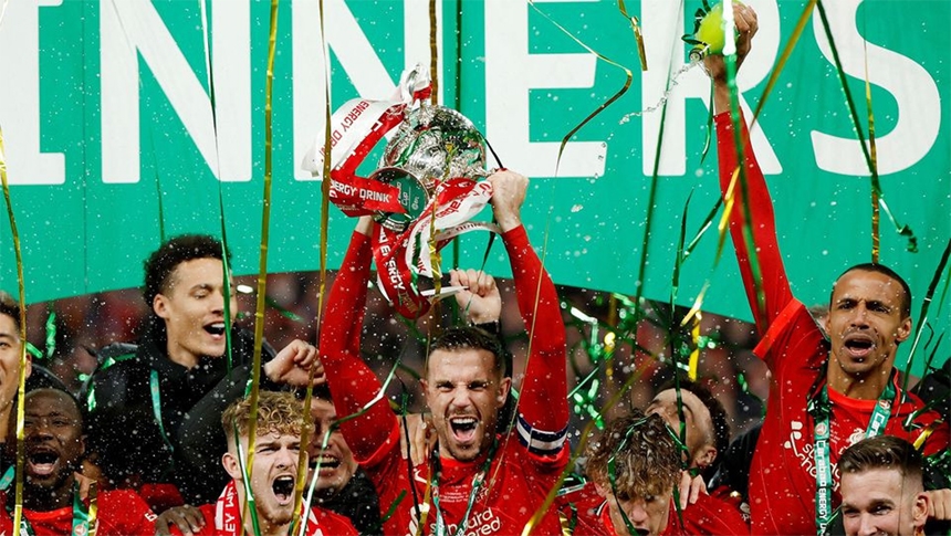 Liverpool players celebrate with the winner's trophy after the English League Cup final football match between Chelsea and Liverpool at Wembley Stadium, north-west London on Sunday.