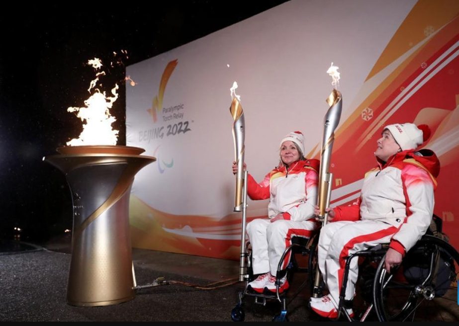 Torch bearers Aileen Neilson (right) and Angie Malone, wheelchair curlers, hold their torches during the Paralympics Heritage Flame Lighting Ceremony for the Beijing 2022 Winter Paralympic Games in Stoke Mandeville, Britain on Monday. Agency photo