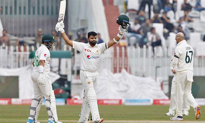 Pakistan's Azhar Ali (centre) celebrates after completing his century during the second day of the first Test match between Pakistan and Australia at the Pindi Stadium on Saturday.