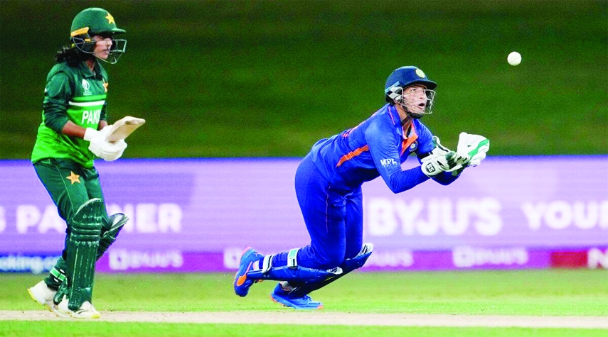 Richa Ghosh (right) of India takes catch to dismiss Nashra Sandhu of Pakistan during the Women's World Cup Cricket match between India and Pakistan at Bay Oval in Mount Maunganui, New Zealand on Sunday.