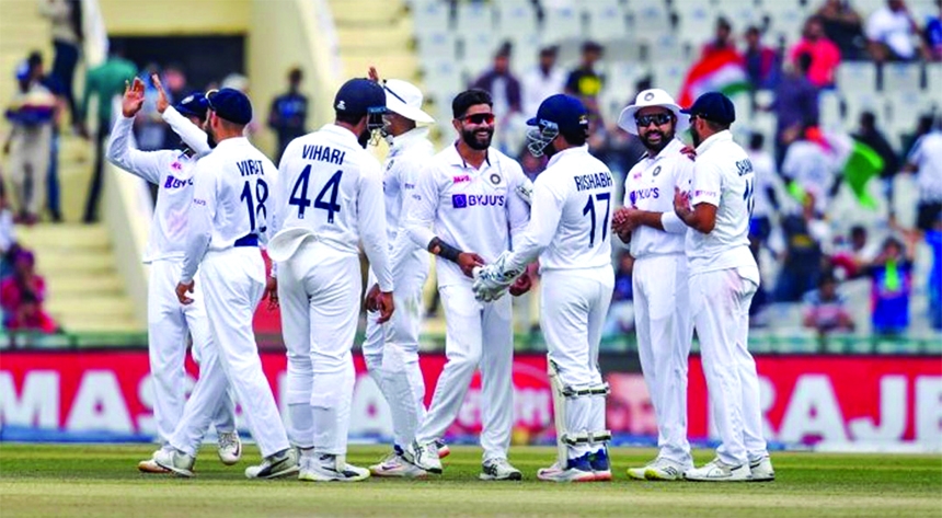India players celebrate during their first Test triumph over Sri Lanka on Day 3 at Mohali, India on Sunday.