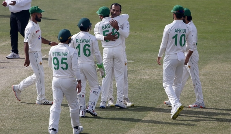 Pakistan's Nauman Ali (center) celebrates with teammates after taking the wicket of Australia's Pat Cummins during the 5th day of the first Test match between Pakistan and Australia at Rawalpindi Stadium on Tuesday. AP photo