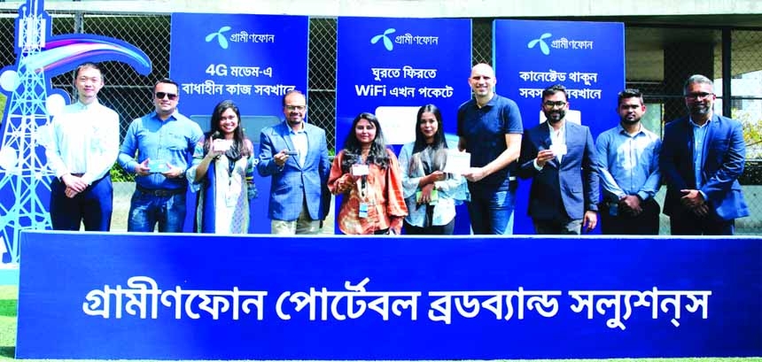 Sajjad Hasib, Chief Marketing Officer along with other officials of Grameenphone, poses for photo after inaugurating its 4G modem, routers at GP office in the capital recently.