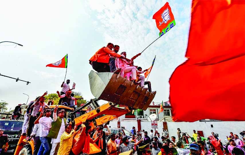 Supporters of India's Bharatiya Janata Party (BJP) celebrate outside the party office in Lucknow on the day of counting of votes for the Uttar Padesh state asembly elections on Thursday.