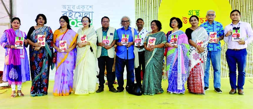 Poet Asad Chowdhury, among others, holds the copies of two books titled 'Nirbachito Kishore Alo' and 'Nirbachito Chhara' written by Tahmina Koraishi organised by Parijat Prokashoni at Amar Ekushey Book Fair in the city's Suhrawardy Udyan on Friday.