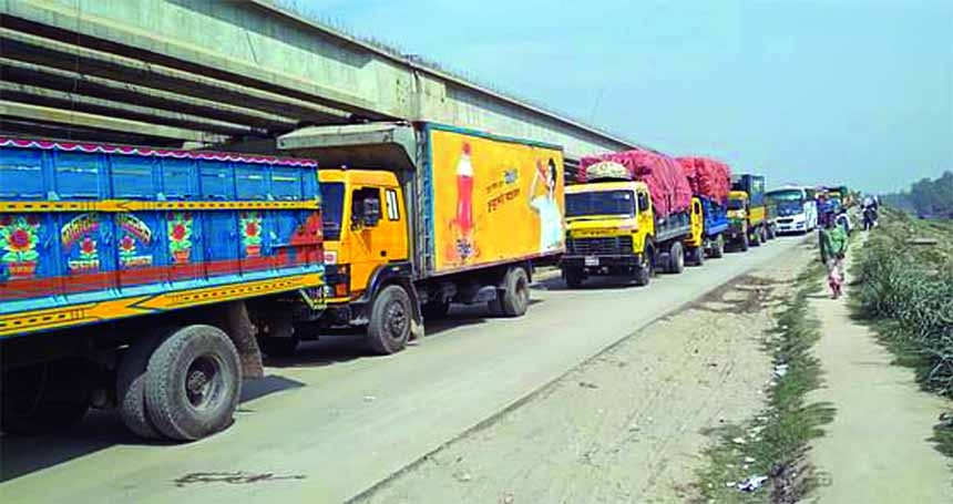 Hundreds of vehicles including good-laden trucks get stuck with long tailback stretching 7 kilometres at Daulotdia-Paturia ghat on Friday.
