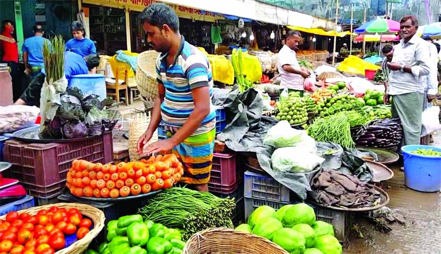 Vegetable vendors wait for customer at Karwan Bazar kitchen market in the capital on Friday. Karwan Bazar is one of the largest wholesale kitchen marketplaces in Dhaka city.