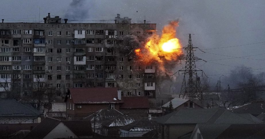 An explosion is seen in an apartment building after Russian's army tank fires in Mariupol, Ukraine, Friday, March 11, 2022.