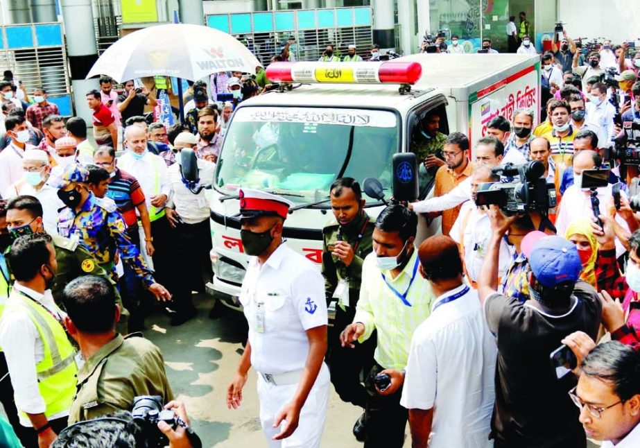 Colleagues and relatives of the third engineer of 'Banglar Samriddhi' Md Hadisur Rahman make way for the ambulance carrying his dead body in the capital on Monday. NN photo