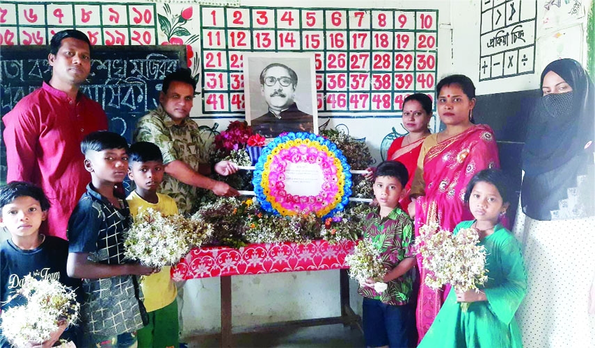 SRIMANGOL (Habiganj): Tea labourers place wreaths at the portrait of Banganbandhu Sheikh Mujibur Rahman at Chatali Cha Bagan Government Pry School in Kalapur Union marking his 102nd birthday and the National Children's Day on Thursday.