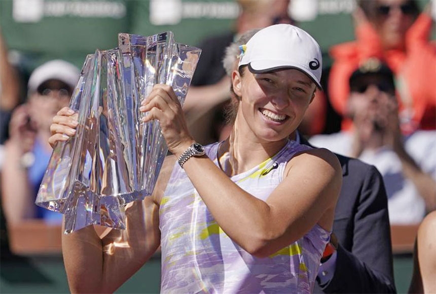 Iga Swiatek of Poland, smiles as she holds her trophy after defeating Maria Sakkari of Greece, in the women's singles final at the BNP Paribas Open tennis tournament in Indian Wells, California on Sunday.