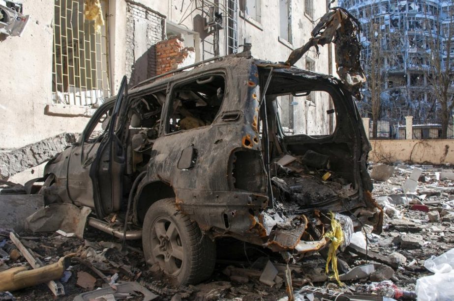 A car destroyed by shelling is seen in a street in Kharkiv, Ukraine, Tuesday, March 22, 2022.
