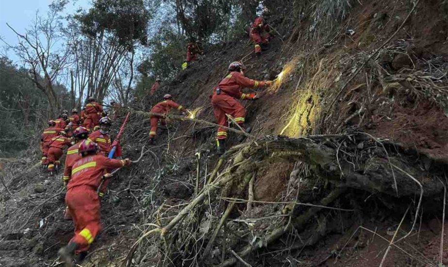 In this photo released by Xinhua News Agency, rescuers conduct search operations at the site of a plane crash in Tengxian County in southern China's Guangxi Zhuang Autonomous Region, Tuesday, March 22, 2022.