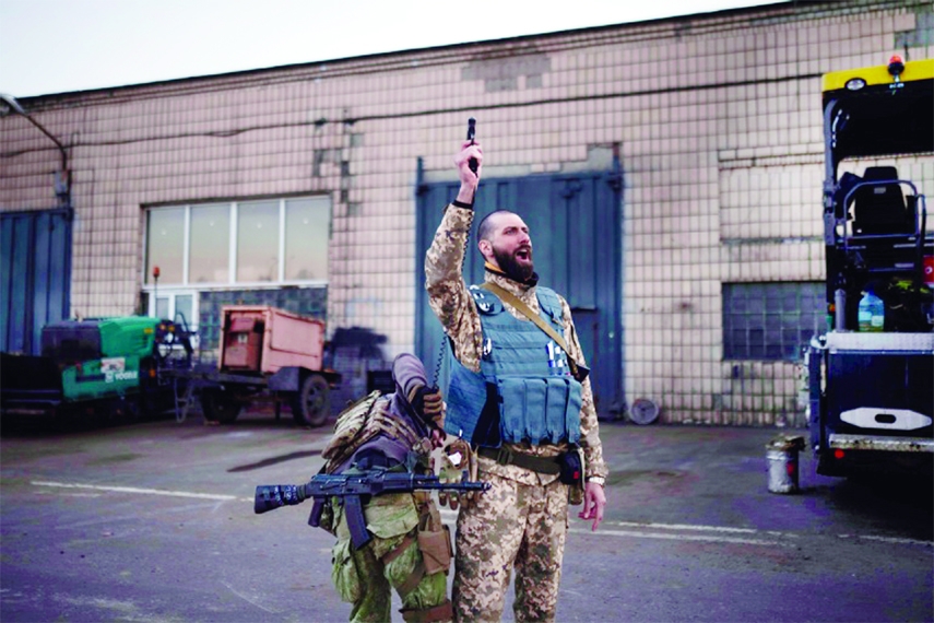 Serhii Volosovets, a commander in the Ukrainian Territorial Defense Forces, fires a pistol during a training camp for volunteers in Brovary, northeast of Kyiv.