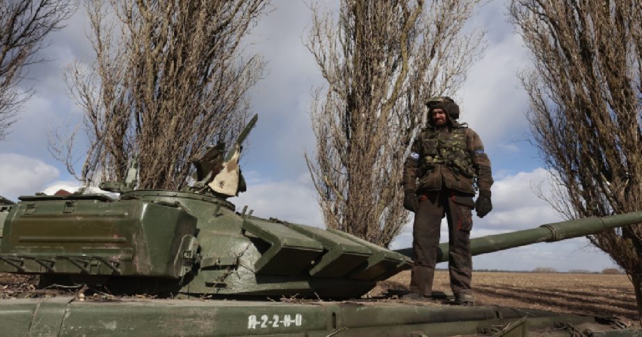 A Ukrainian serviceman stands on a tank in the village of Lukyanivka, Kyiv region, Ukraine, Monday, March 27, 2022.