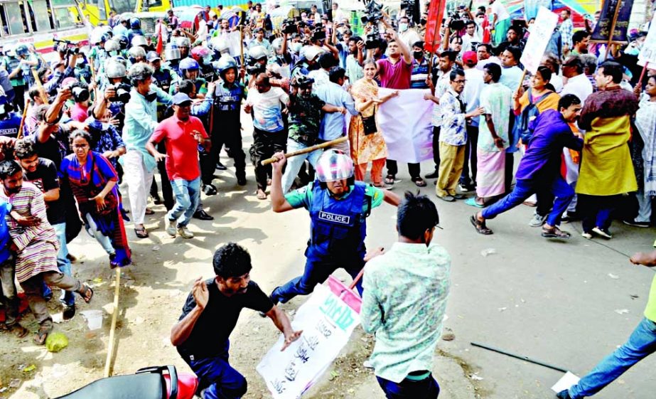 Police charge baton to disperse the hartal supporters as they blocked Paltan intersection in the capital on Monday. NN photo