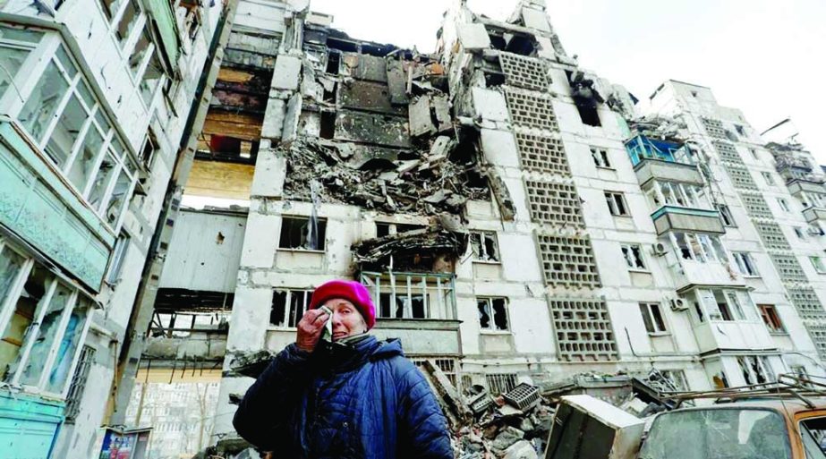 A Ukrainian woman reacts next to the building where her apartment, destroyed during Ukraine-Russia conflict, is located in the besieged southern port city of Mariupol on Sunday. Agency photo