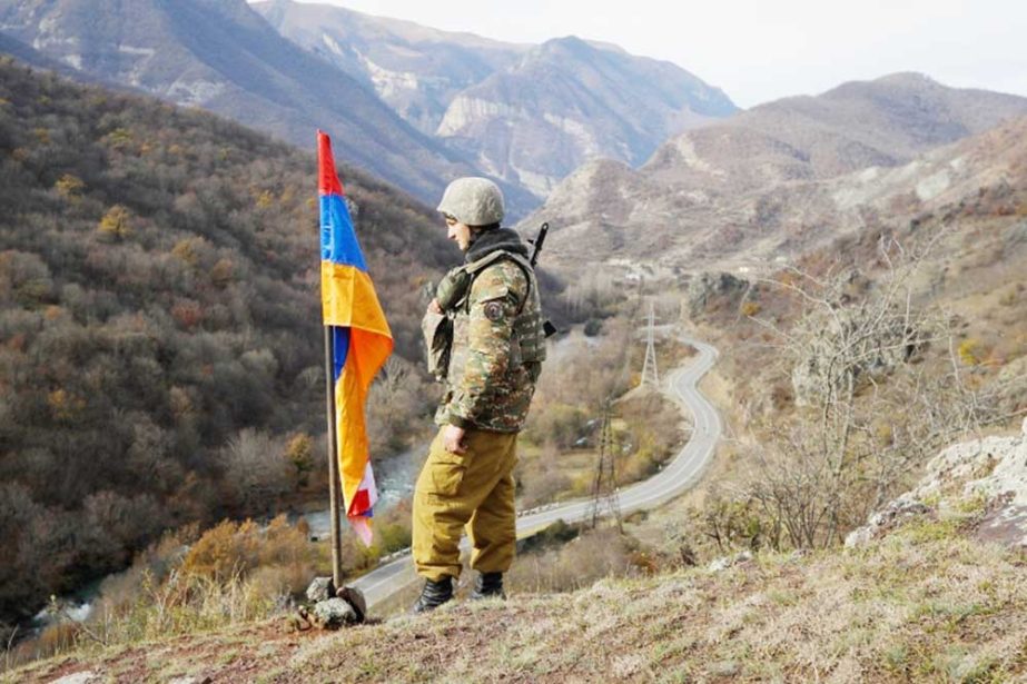 An ethnic Armenian soldier stands guard next to Nagorno-Karabakh's flag Agency photo