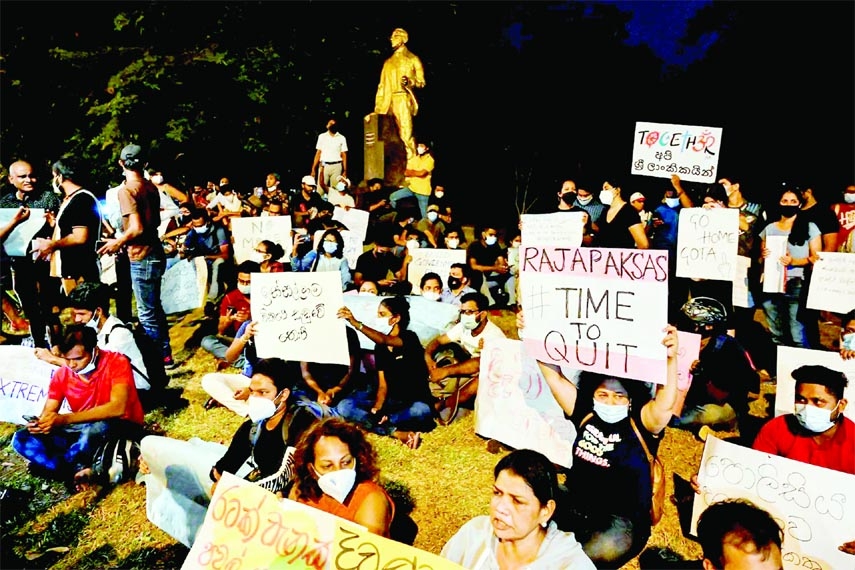 Protesters hold banners and placards during a demonstration against the surge in prices and shortage of fuel and other essential commodities in Colombo, Sri Lanka on Friday night.