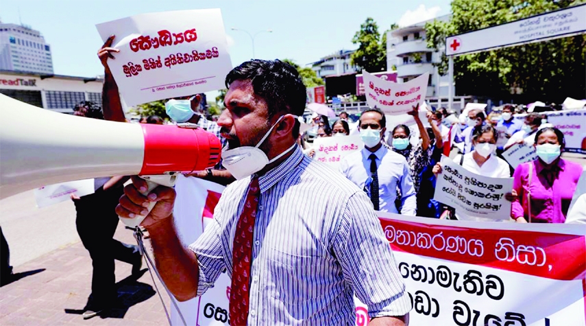 Government Medical Officers' Association members walks with placards against the Sri Lanka's President Gotabaya Rajapaksa during a protest near a road leading to the parliament building in Colombo, Sri Lanka on Wednesday.