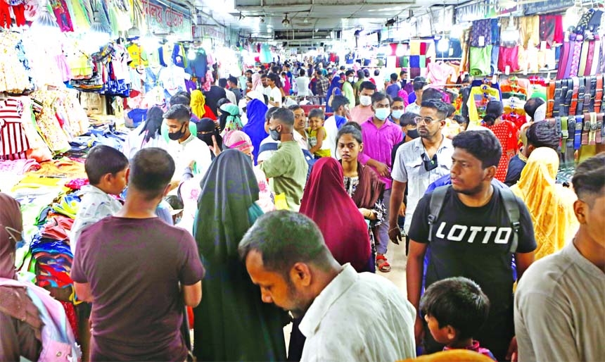 Eid shoppers throng the capital's New Super Market on Friday morning but social distancing and other health guidelines remained a far cry for both customers and shopkeepers.