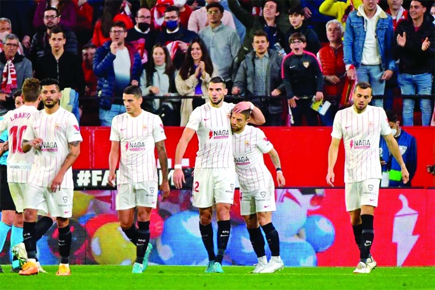 Sevilla's Spanish forward Rafa Mir (2nd left) celebrates after scoring a goal that was later cancelled by the referee during the Spanish League football match between Sevilla FC and Granada FC at the Ramon Sanchez Pizjuan stadium in Seville on Friday.