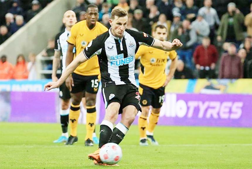 Newcastle United's Chris Wood scores the opening goal from the penalty spot during the English Premier League football match against Wolves at St James' Park in Newcastle-upon-Tyne, northeast England on Friday.