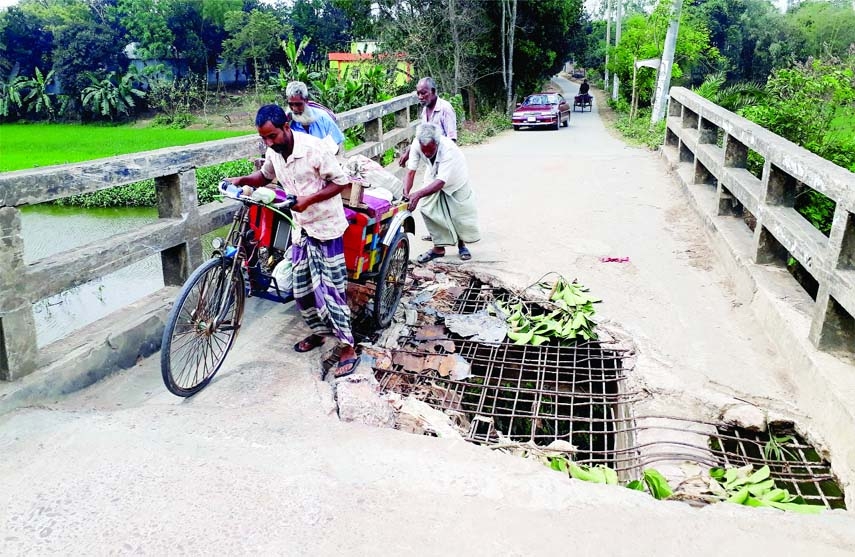 MIRZAPUR (Tangail): The broken bridge over Pakuya canal on Pathorghata- Pakuya Road in Mizapur Upazila needs immediate repair as vehicles uses the risky bridge. The picture was taken on Thursday.