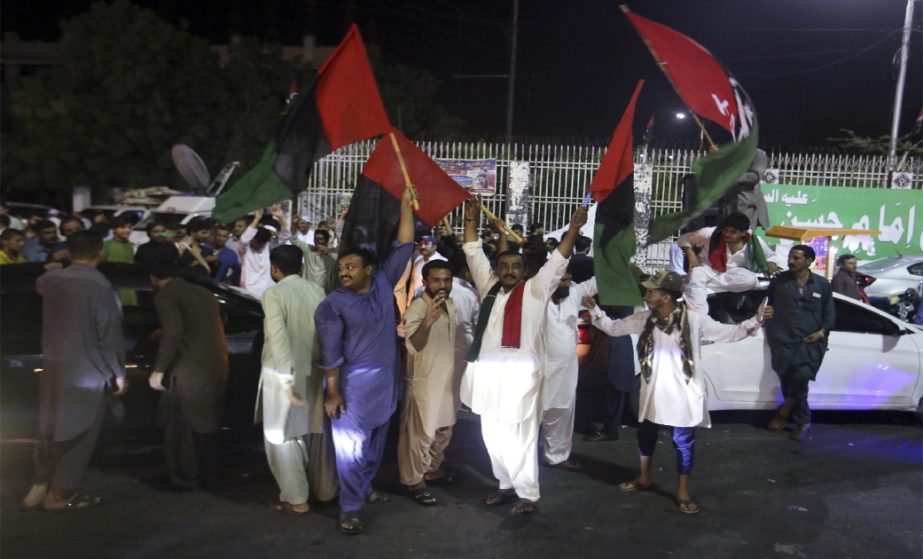Supporters of an opposition party celebrate the success of a no-confidence vote against Prime Minister Imran Khan, in Karachi, Pakistan, Sunday, April 10, 2022.