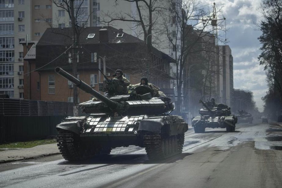 Ukrainian tanks move in a street in Irpin, in the outskirts of Kyiv, Ukraine, Monday, April 11, 2022.