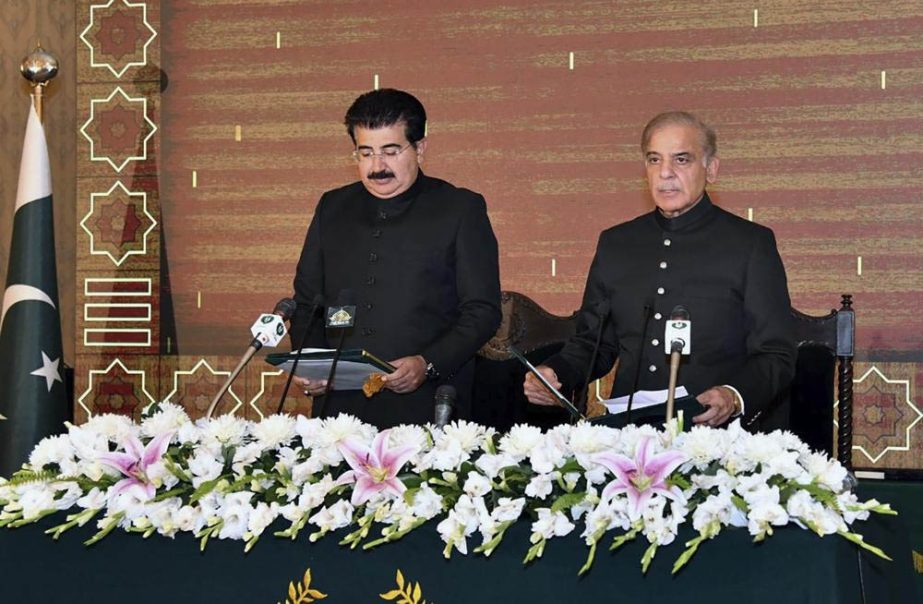 Acting President of Pakistan Sadiq Sanjrani, left, administers the oath of office to newly elected Pakistani Prime Minister Shahbaz Sharif during a ceremony at Presidential Palace, in Islamabad, Pakistan, Monday, April 11, 2022.